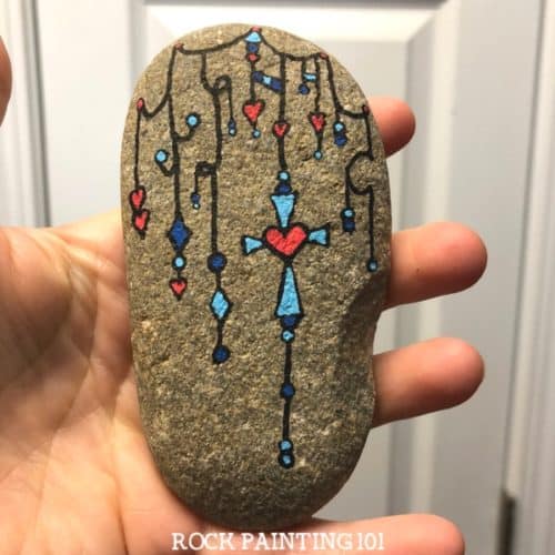 Dangle Art Cross Rocks ~ Beautiful Christian rock painting ideas. Use zendangle technique to create a rock with a cross.