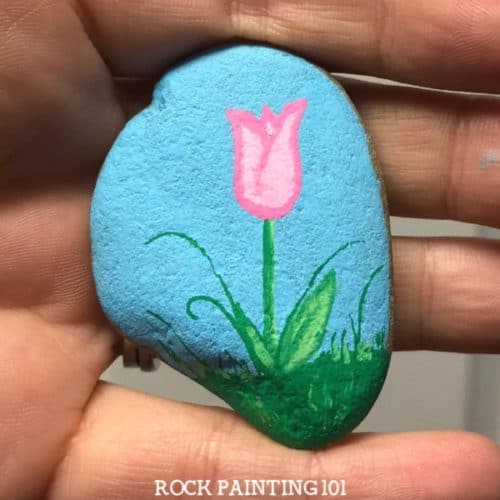 These tulip painted rocks are the perfect rock painting idea for spring! Learn how to draw a tulip while creating a rock that's perfect for hiding, gifting, or decorating!