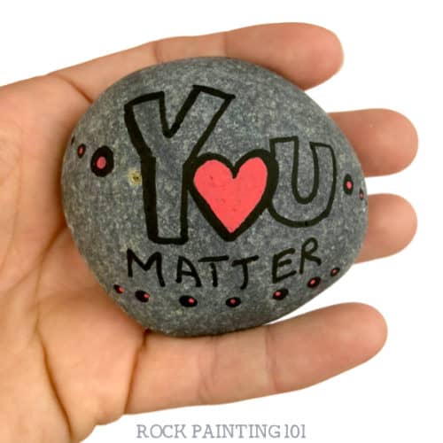 Are you participating in International Drop A Rock Day? Check out all the fun details about this fun day that takes rock hunting to a new level by spreading love and kindness around the world. #internationaldroparockday #droparock #kindnessrocks #youmatter #redheart #howtopaintrocks #rockpainting101