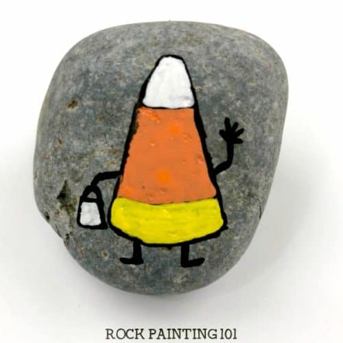 Create adorable candy corn painted rocks with this simple and fun tutorial. This Halloween rock painting idea is perfect for trick or treaters or to decorate this season! #halloweenrockpainting #candycorn #candy #paintedrocks #halloweencandy #trickortreat #noncandyhalloween #rockpainting101
