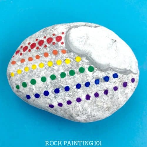 This fun dotted rainbow rock is perfect for beginners and makes a fun kindness rock painting idea! #rainbow #rockpainting #kindnessrocks #bearainbow #howtopaintrocks #rockpaintingideas #stonepainting #paintedrocks #rockart #rockpainting101