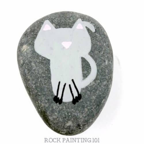 Learn how to paint a cat on rocks with this simple video tutorial. Grab your paint pens or your favorite paint brush and let's create this easy stone painting idea. #catrocks #howtopaintacat #rockpaintingidea #paintedrocks #stonepaintingideas #rockpainting101
