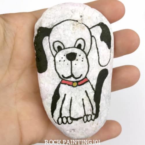 Learn how to paint a dog for a fun and easy painted rock. A style of painting perfect for beginners. Grab your paint pens or paintbrush and let's paint! #dog #paintedrock #howtopaintadog #howtodrawadog #dogrocks #videotutorial #rockpainting101