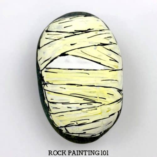 Learn how to draw a mummy on rocks with this fun video tutorial. Grab some paint pens and let's begin this fun spooky Halloween stone painting idea. #halloweenrockpainting #mummy #howtodrawamummy #howtopaintamummy #mummyrocks #rockpaintingideas #paintedrocks #stonepainting #rockpainting101