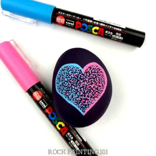This easy pointillism tutorial is perfect for rock painting beginners. We used this art technique to create a heart rock, but you can paint any shape you want! #pointillism #heart #rockpainting #art #rockart #heartrock #stonepainting #posca #paintpens #rockpainting101