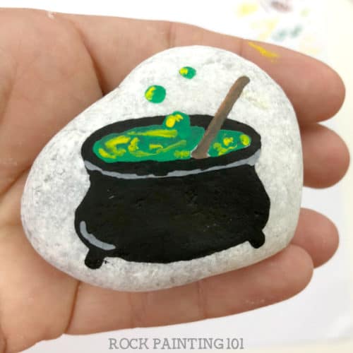Witches cauldron Halloween painted rocks.