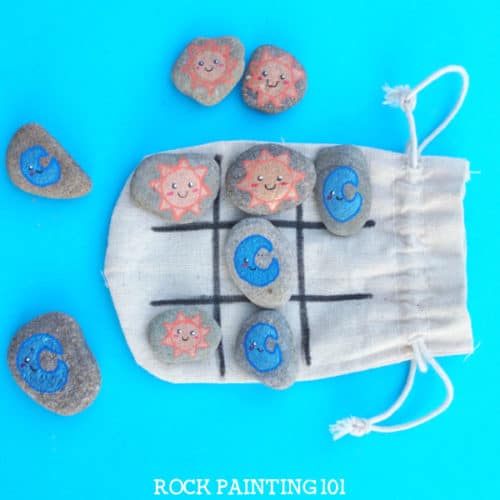 Make tic tac toe rocks that are the perfect boredom buster for kids. They also make amazing gifts! Check out the video tutorial and a collection of ideas for your set. #tictactoe #rocks #travelgame #rockpaintingideas #rockgames #rockgifts #rockpainting101