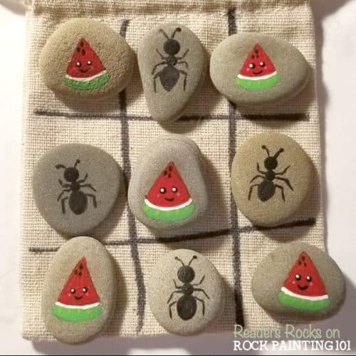 Make tic tac toe rocks that are the perfect boredom buster for kids. They also make amazing gifts! Check out the video tutorial and a collection of ideas for your set. #tictactoe #rocks #travelgame #rockpaintingideas #rockgames #rockgifts #ants #watermelon #summer #rockpainting101