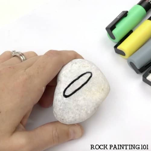 Paint a witch's cauldron with this step by step tutorial. This spooky fun Halloween rock painting idea is perfect for beginners! #witchescauldron #halloweenrocks #paintedrocks #rockpaintingideas #howtopaintbubbles #rockpainting101