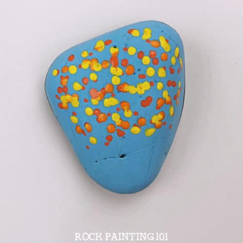 Learn how to use dot painting to make beautiful fall tree painted rocks. This beginner's rock painting idea is perfect for hiding around your neighborhood this fall! #dotpainting #falltree #fallrocks #stonepainting #paintedrocks #howtopainttrees #rockpainting101