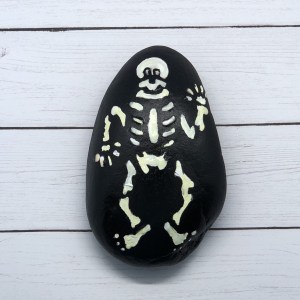 Use stencils to create a spooky skeleton painted rock.