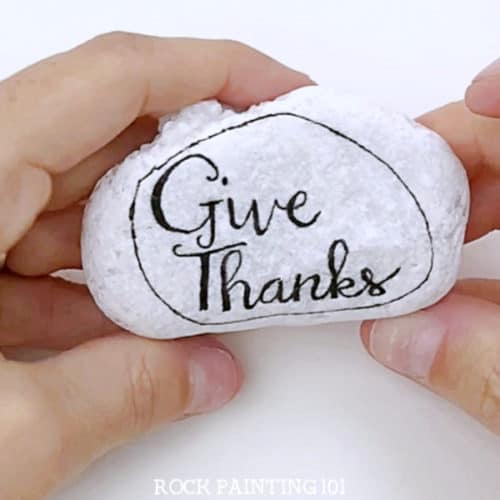 Make beautiful hand lettered Thanksgiving rocks with this step by step tutorial. Hand lettering has always been hard for me, but these practice sheets are perfect for learning! #handlettering #thanksgivingrocks #givethanks #howtohandletter #kindnessrocks #thanksgivingrockpainting #howtopaintrocks #rockpainting101