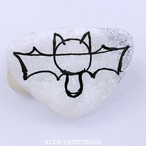 Learn how to paint a bat to make these spooky and fun Halloween painted rocks. Follow along with these step by step instructions and you'll be hiding bat painted rocks in no time! #batrocks #paintedrock #howtopaintabat #halloweenpaintedrocks #rockpaintingideas #stonepainting #rockpainting101