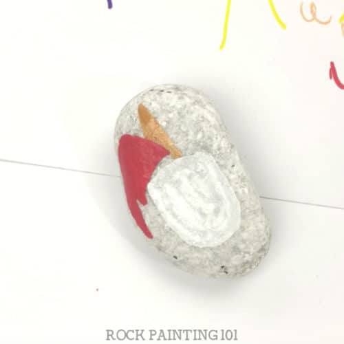 This Christmas unicorn painted rock is perfect for giving this holiday season. Watch the tutorial and see just how easy it is to paint. #christmas #unicornrocks #paintedrocks #videotutorial #stockingstuffer #iloveunicorns #rockgifts #howtodrawaunicorn #rockpainting101