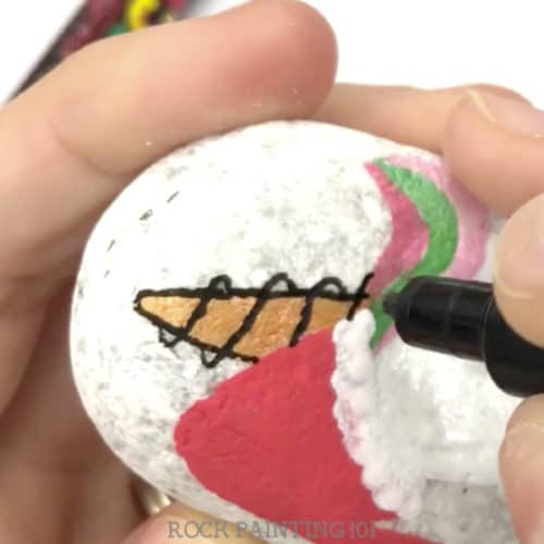 This Christmas unicorn painted rock is perfect for giving this holiday season. Watch the tutorial and see just how easy it is to paint. #christmas #unicornrocks #paintedrocks #videotutorial #stockingstuffer #iloveunicorns #rockgifts #howtodrawaunicorn #rockpainting101
