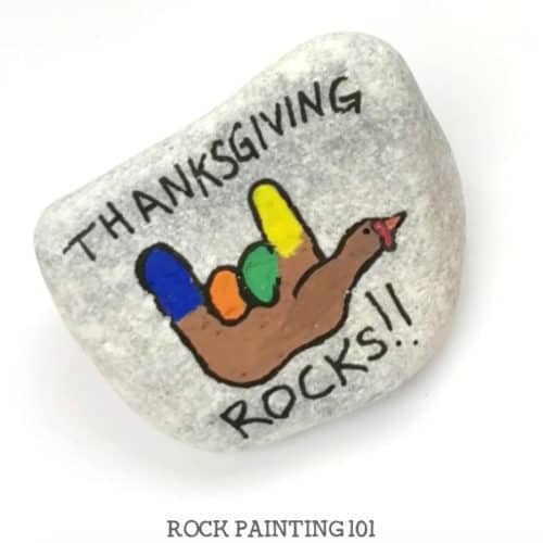 This fun Thanksgiving Rocks turkey painted rock is perfect for giving this holiday season. Brighten someone's day or use it to decorate your holiday table. It's a quick and simple video tutorial. #thanksgivingrocks #turkey #paintedrock #thanksgivingrockpaintingideas #stonepainting #rockart #thanksgivingdecor #thanksgivingcraft #rockpainting101