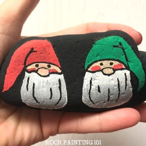 This Christmas gnome rock painting idea is a fun way to paint rocks during the holidays. Learn how to draw a gnome onto a rock with step by step instructions and a video tutorial. #christmasgnome #holidaygnome #christmasrocks #howtodrawagnome #holidayrockpainting #rockpainting101