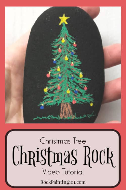 Learn how to paint a Christmas tree for fun holiday rocks. Watch the video tutorial and see just how easy these Christmas stones are to create. They are perfect for stocking stuffers, hiding this winter, or giving to a friend! #christmastree #christmasrockpainting #howtopaintachristmastree #rockpaintingforbeginners #rockart #stonepainting #stockingstuffers #rockpainting101