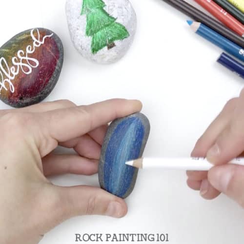 Did you know that you can use colored pencils to paint rocks? This inexpensive and versatile craft supply is perfect for created blended base coats and a smooth surface for hand lettering. #basecoat #coloredpencils #howtopaintrocks #rockpaintingsupplies #rockpainting #forbeginners #rockpainting101