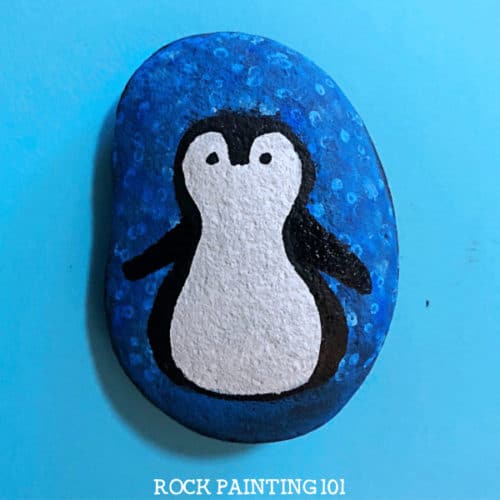 Learn how to draw a penguin for an adorable winter painted rock. Using a block painting process, you'll be able to create this cutie even as a beginner! #penguin #rockpainting #winter #animals #howtodraw #howtopaint #videotutorial #rockpaintingforbeginners #rockpainting101