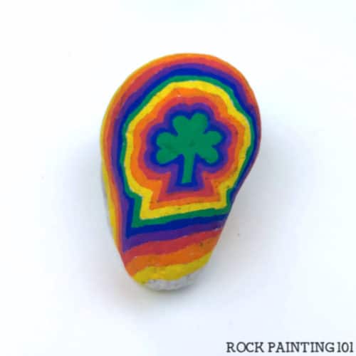 This bright rainbow shamrock rock is a fun St. Patricks Day painting idea!