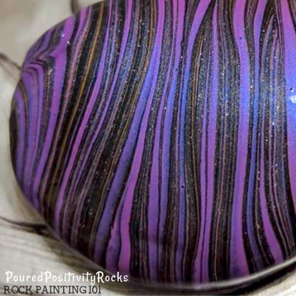 Create beautiful pour painted rocks using these tips for beginners.