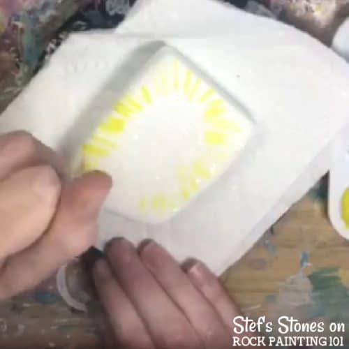 Step by step directions to painting tie dye with alcohol ink on stones.